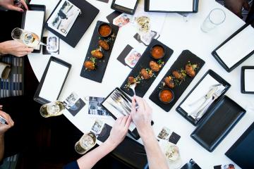 a person holding a bunch of items that are on a table